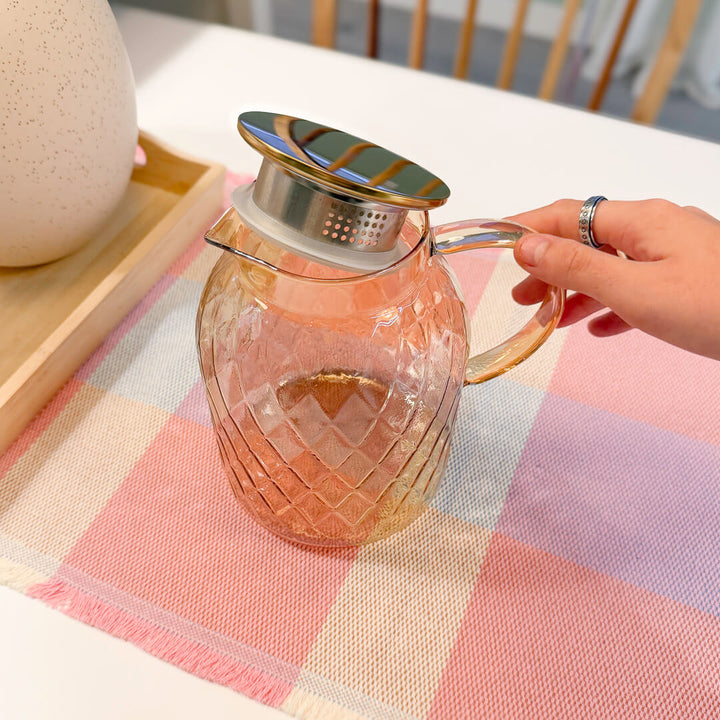 Amber glass pitcher with elegant diamond texture and curved handle