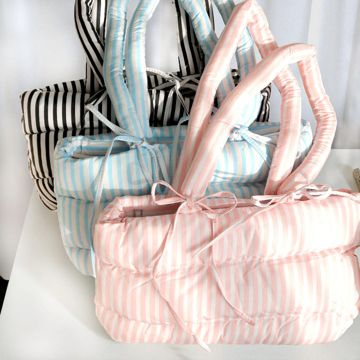Soft padded handbag in pink, blue, and black stripes
