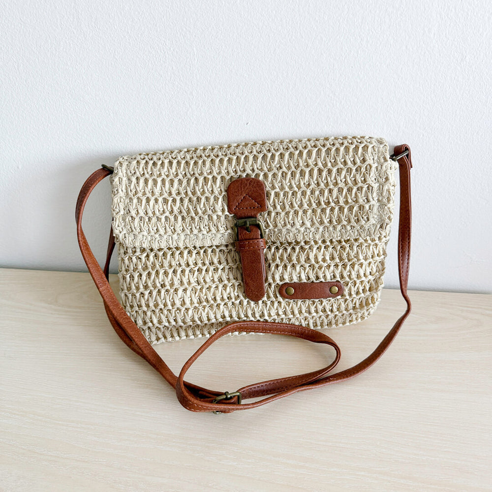 Neutral woven crossbody bag with brown faux leather trim