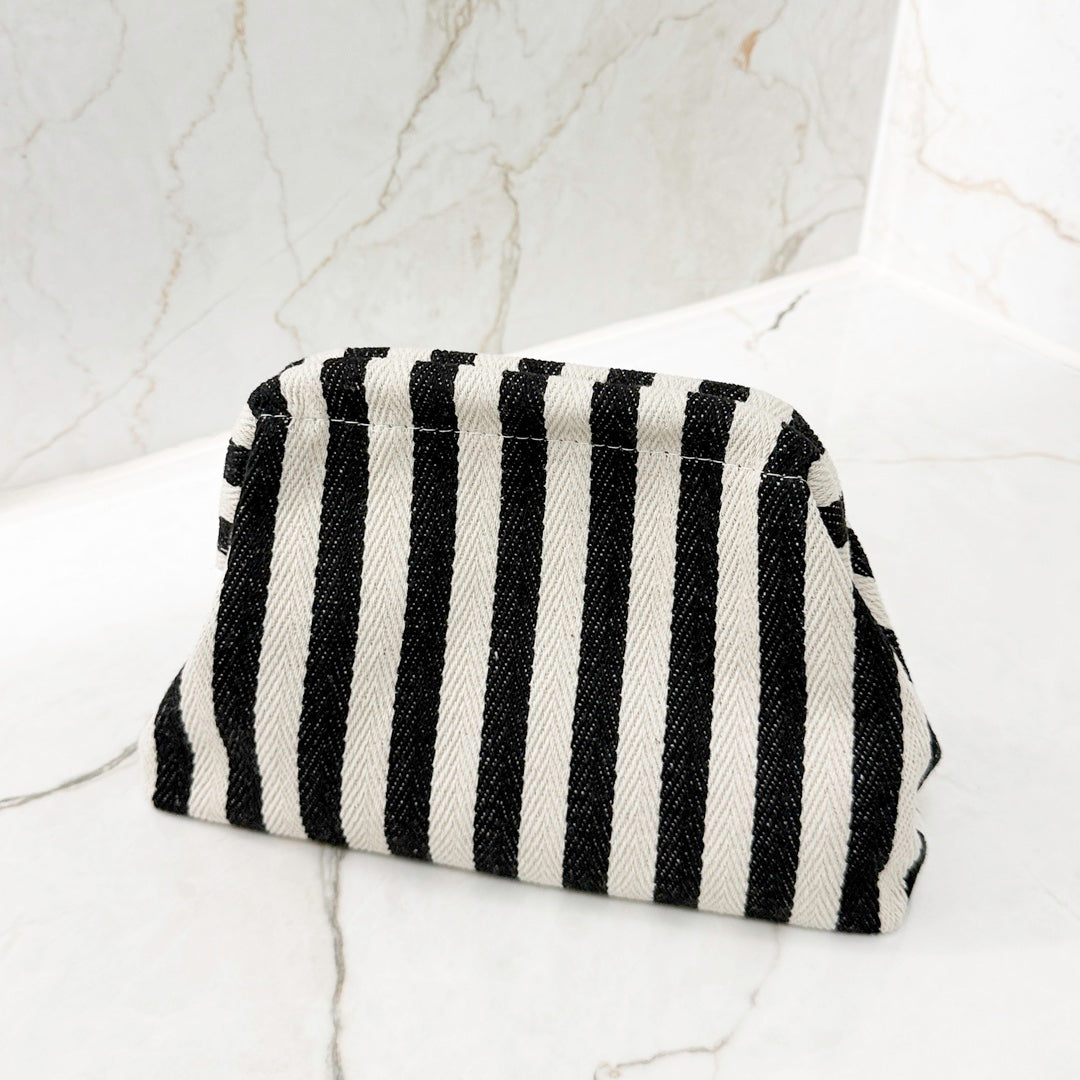 Portable striped handbag for travel essentials