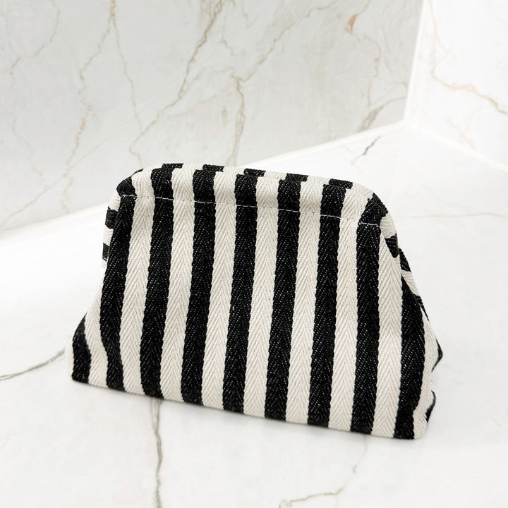 Portable striped handbag for travel essentials