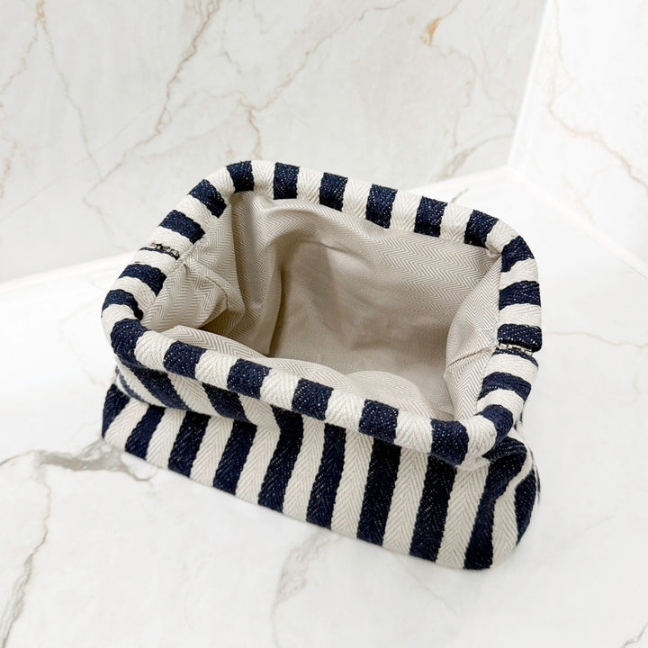 blue makeup bag with bold striped design