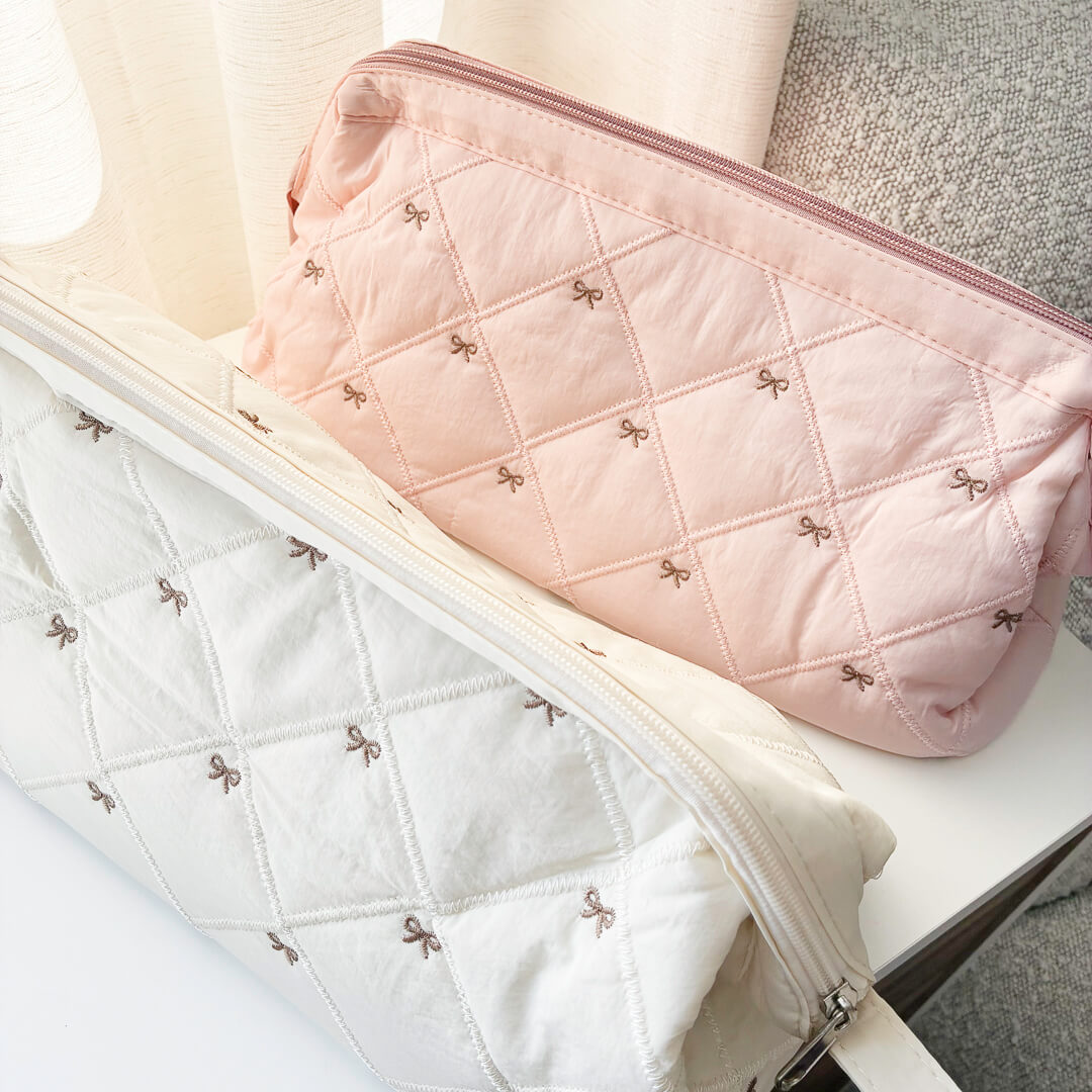 Quilted bow makeup pouch with zipper closure