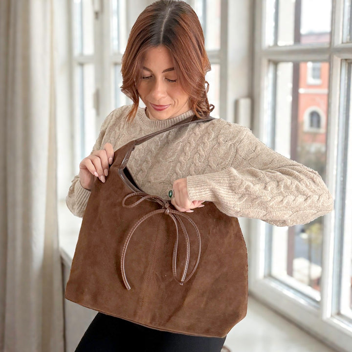 Soft suede shoulder bag featuring a large front bow detail