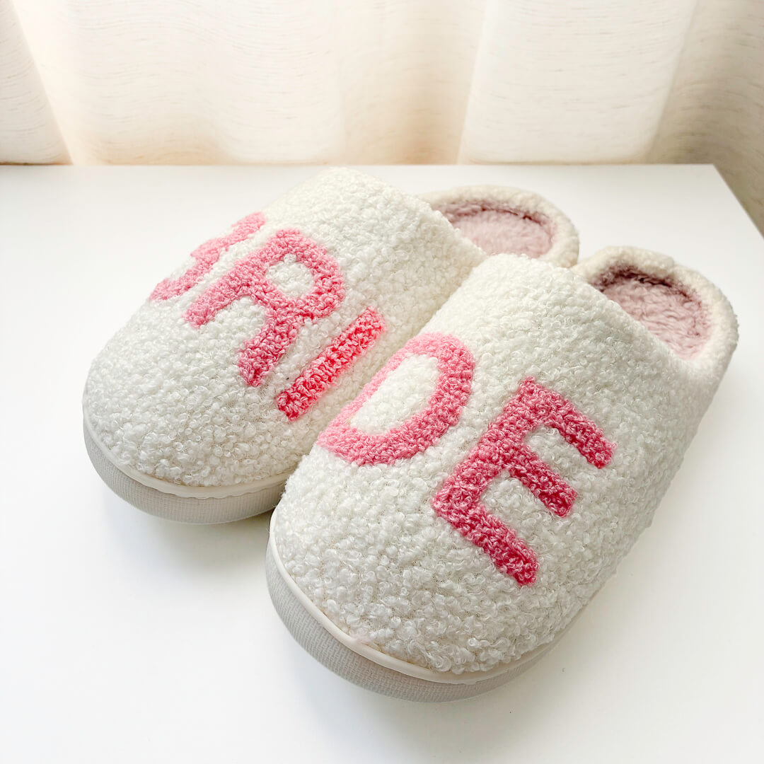 White bridal slippers with pink embroidered lettering