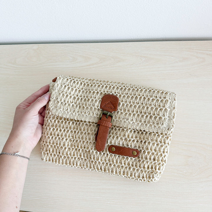 Crossbody bag with natural woven finish and brown strap