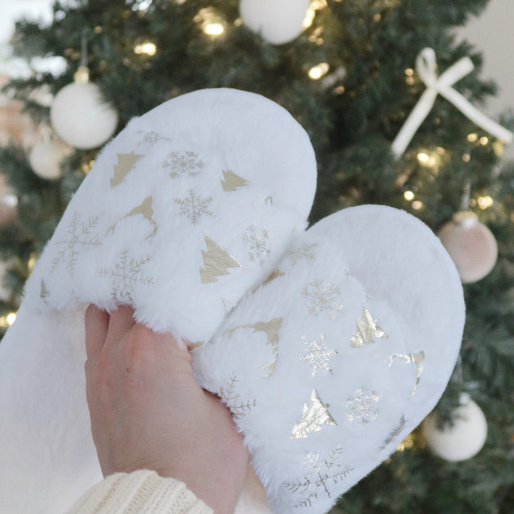 Plush white holiday slippers with gold snowflake and tree details