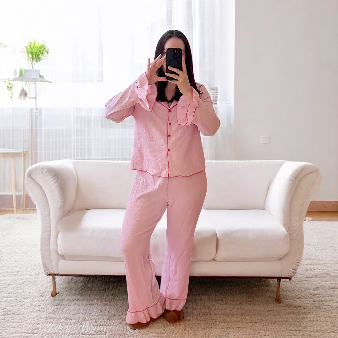 Button-down pink pajama top with matching frilled bottoms
