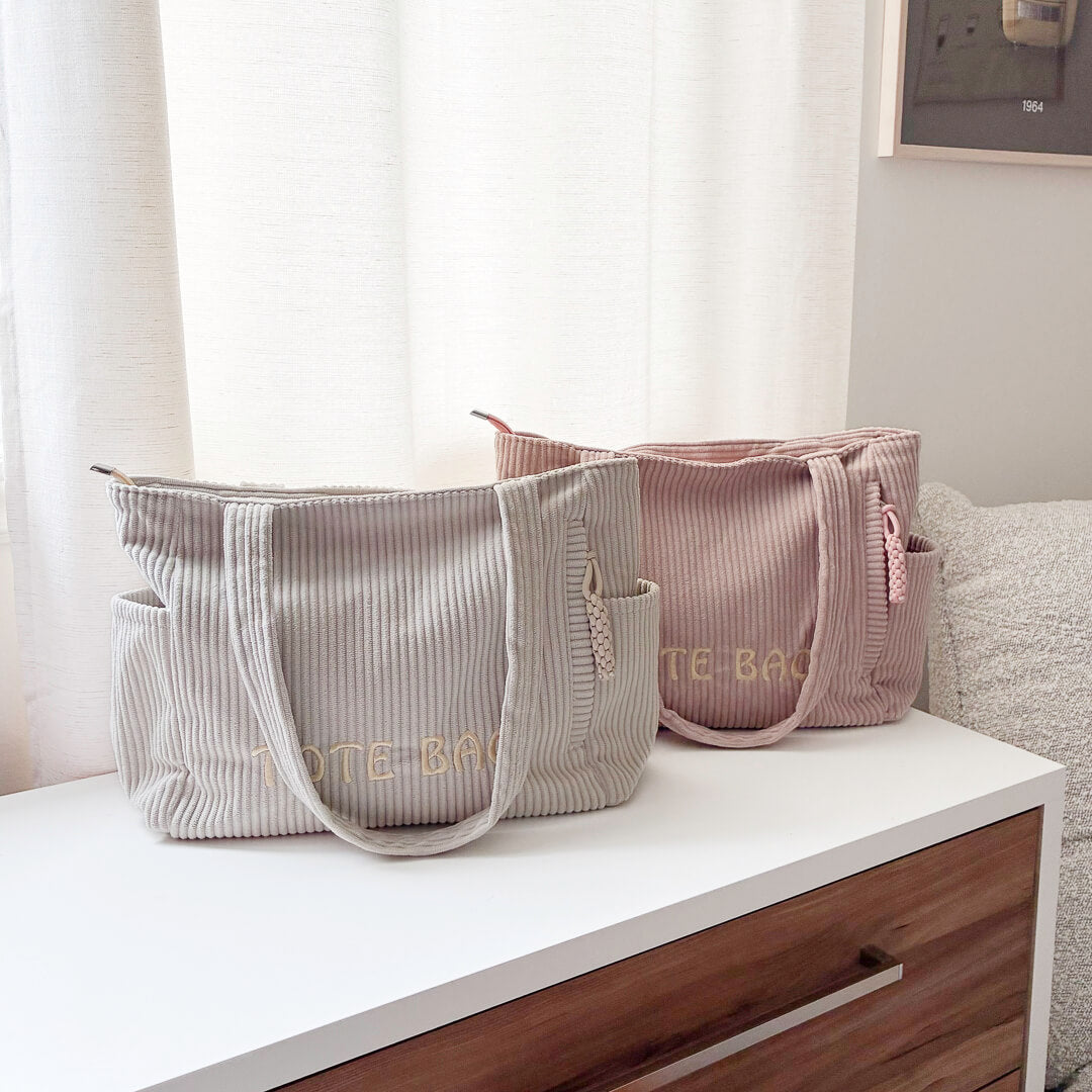Soft ribbed tote bag with side pockets and zipper closure