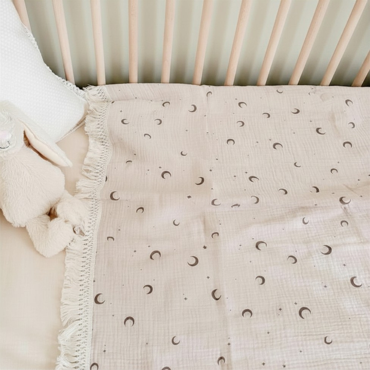 Floral crib blanket with cream fringe edges