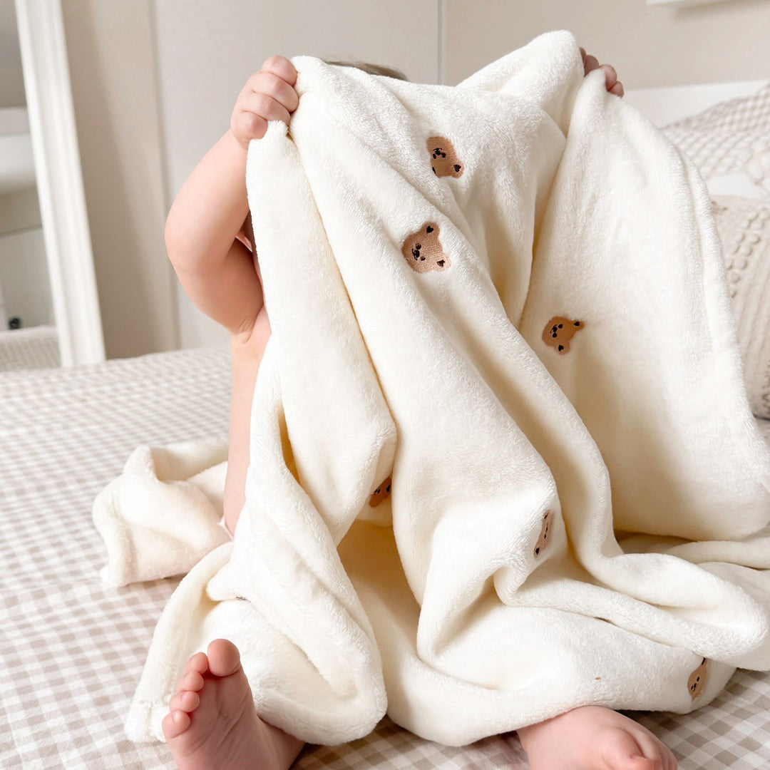 Plush baby blanket featuring cute bear details
