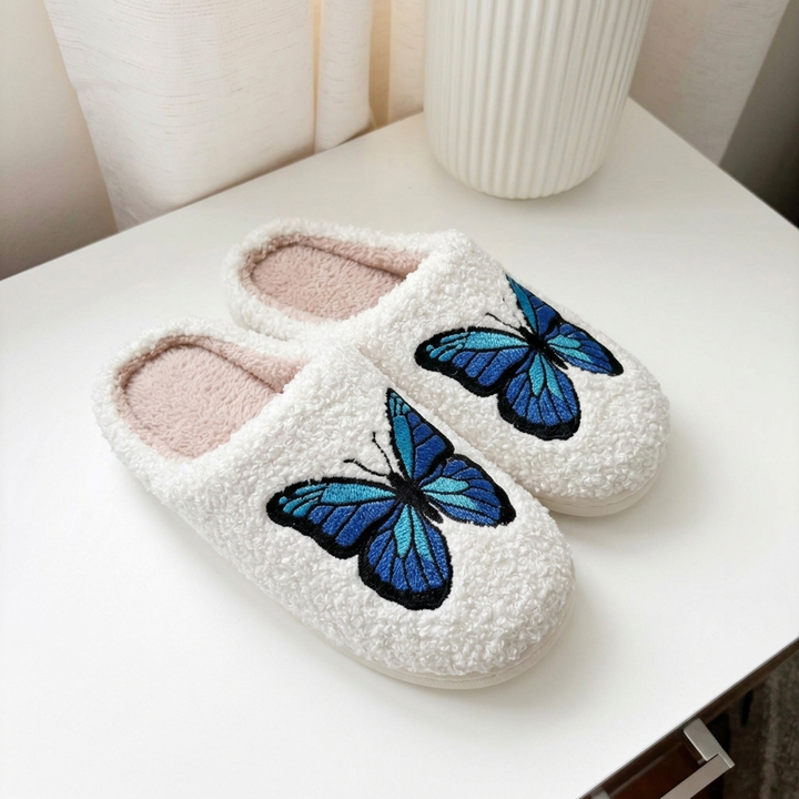 Soft indoor slippers with large blue butterfly detail