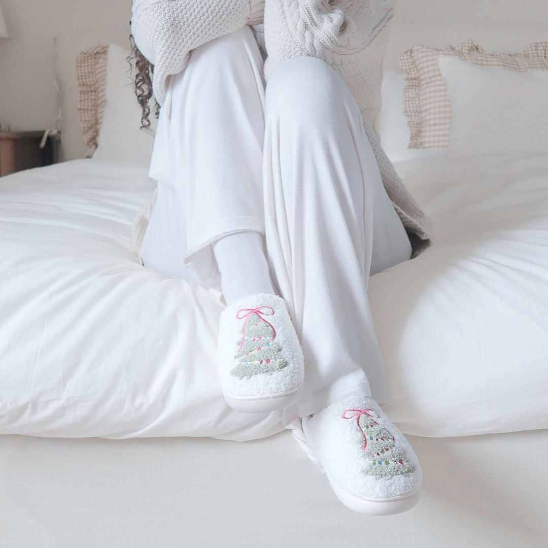 Soft holiday slippers in white with colorful Christmas tree
