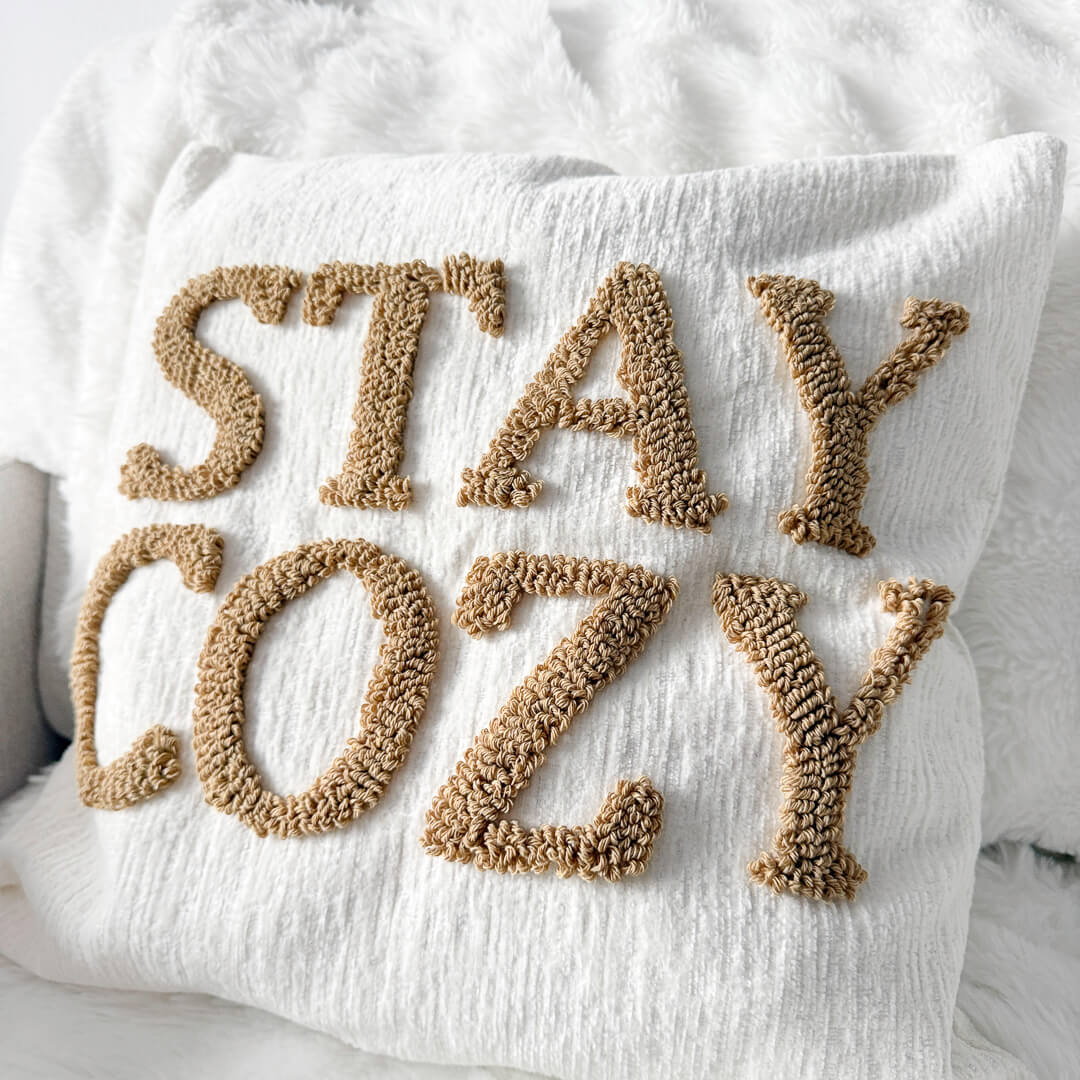 Decorative throw pillow cover with raised stay cozy letters