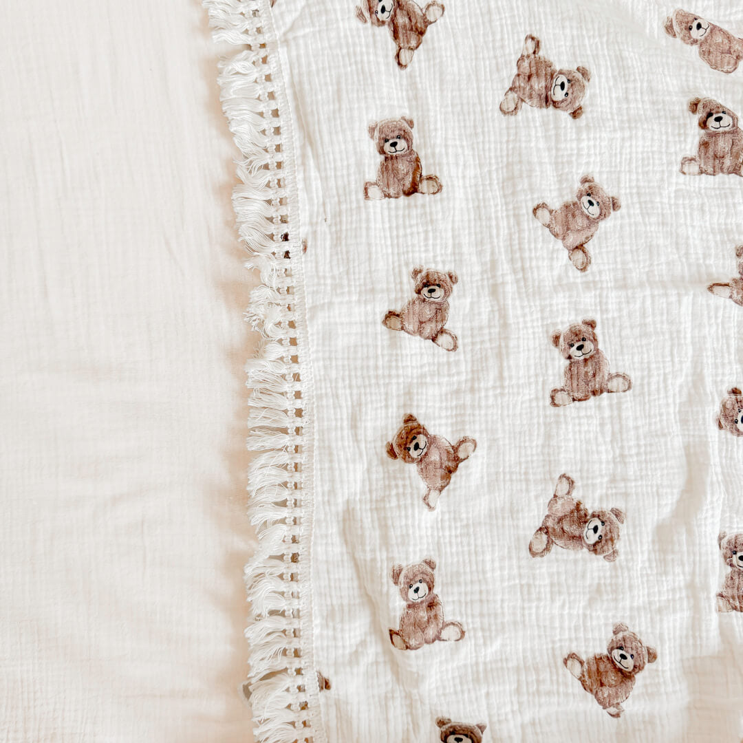 Baby blanket with fringed trim for nursery styling