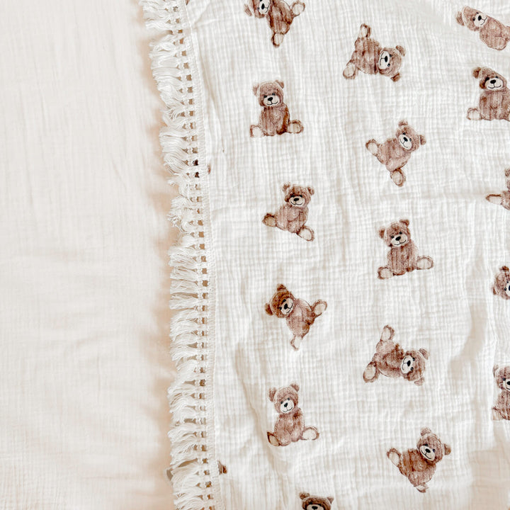 Baby blanket with fringed trim for nursery styling