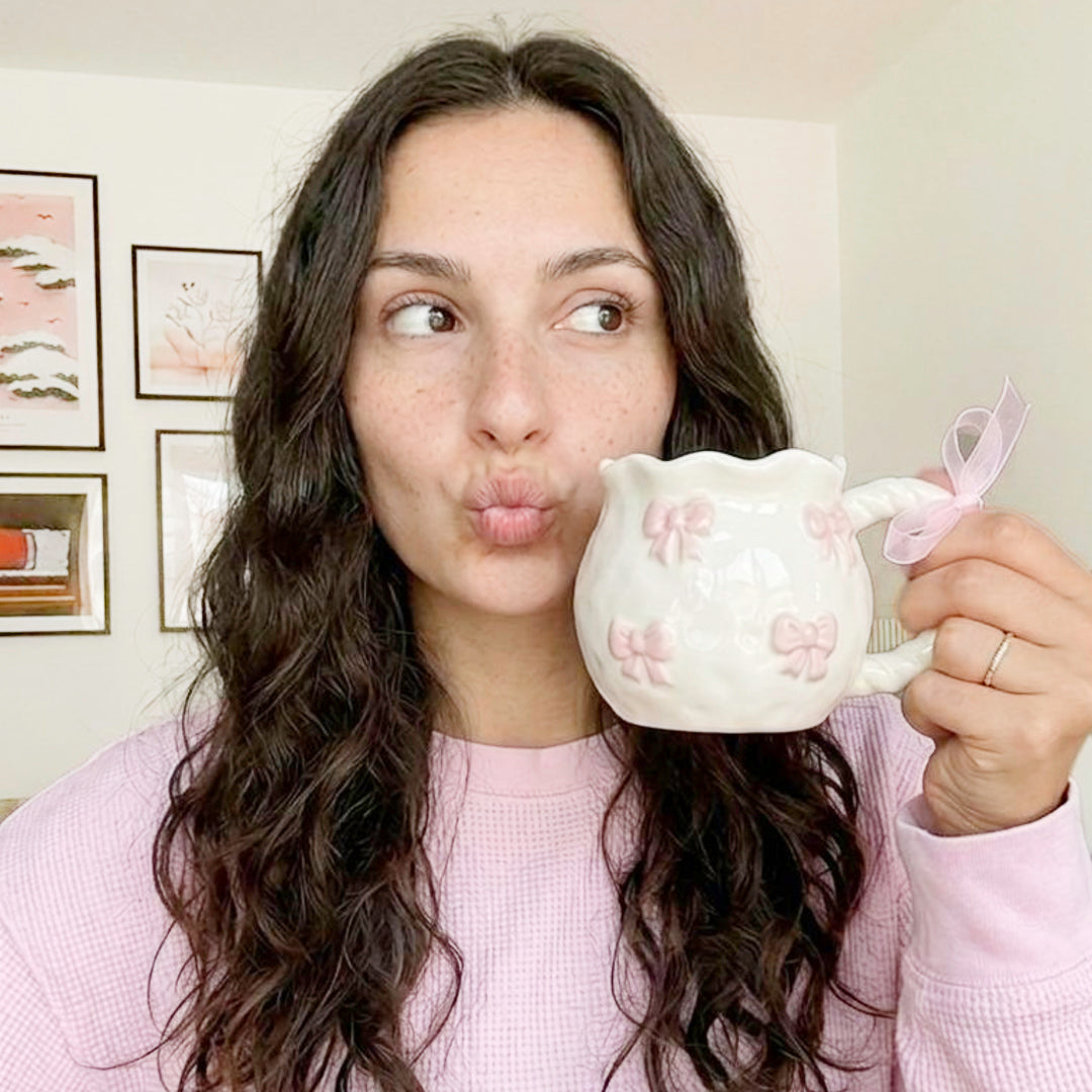 Ceramic coffee mug with raised pink bows