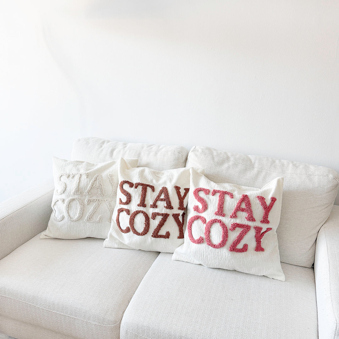 throw pillow cover with warm neutral embroidered text