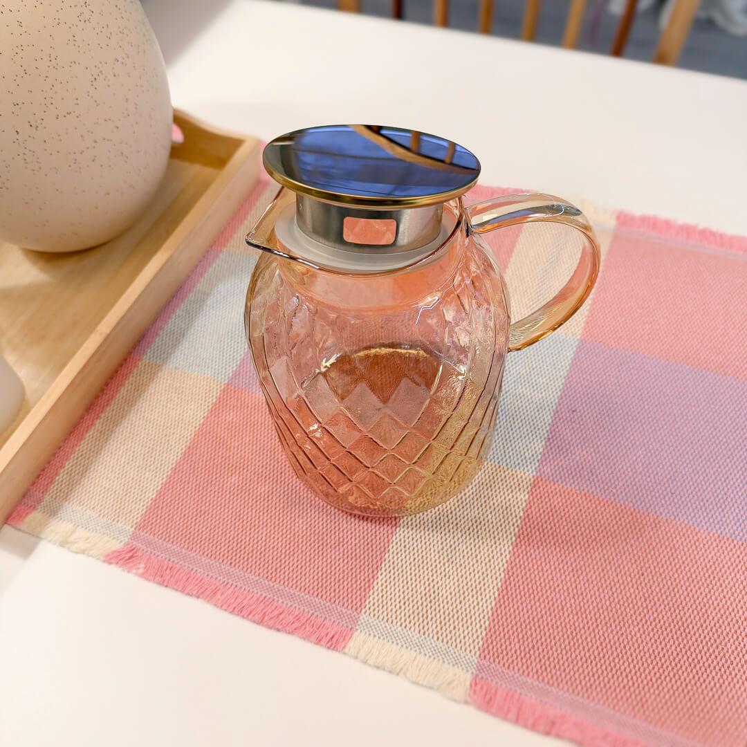 Golden brown glass pitcher with stylish curved handle