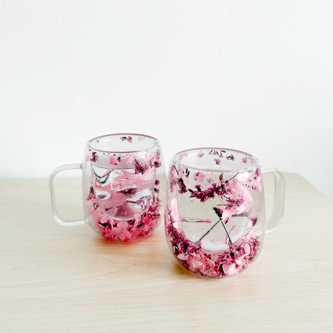Transparent glass mug with pressed flower accents