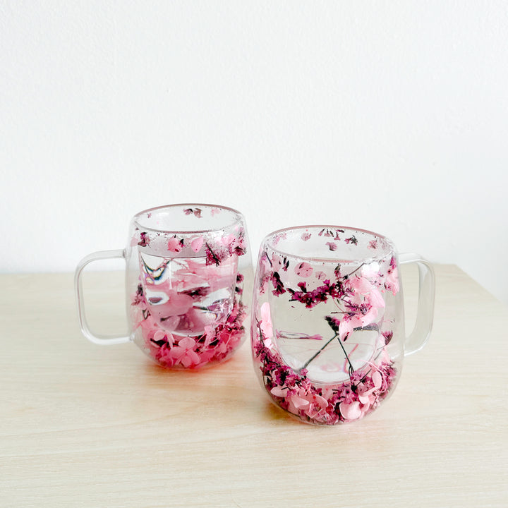 Transparent glass mug with pressed flower accents