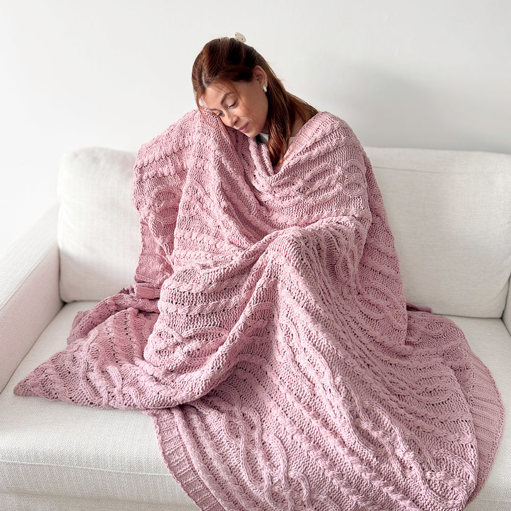 Decorative cable knit blanket with soft pink knitted fabric