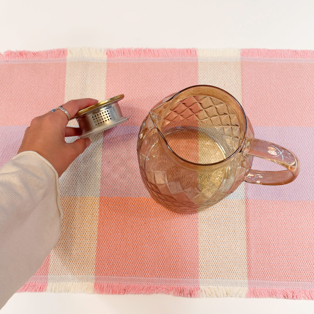 Vintage-inspired glass water pitcher with warm golden brown finish