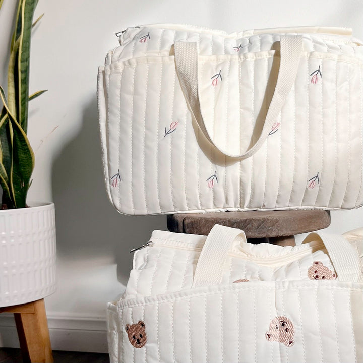 Quilted diaper bag with bear embroidery and side pockets