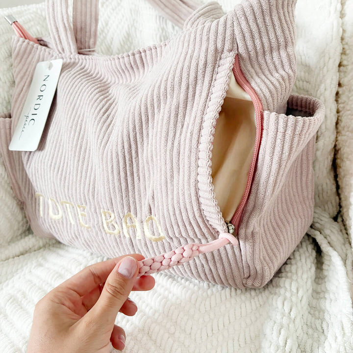 Large textured tote bag with practical side compartments