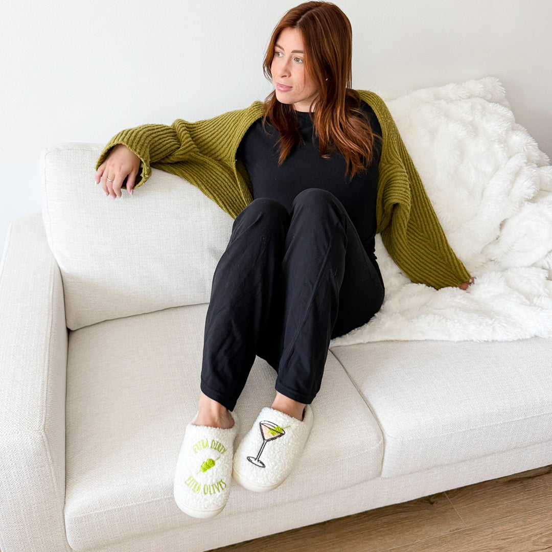 Plush cocktail slippers with green text and glass detail