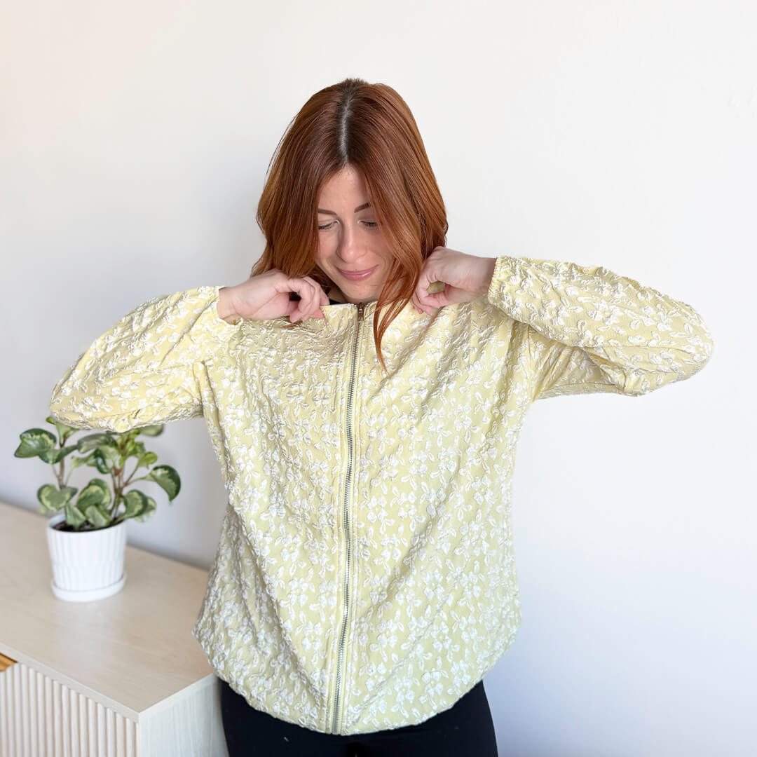yellow women's jacket with full-length zipper closure