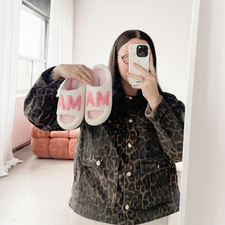 White plush MAMA slippers with bold pink puff letters