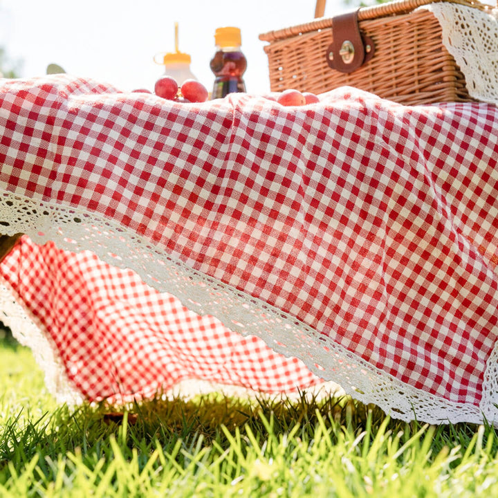 Red gingham picnic blanket with white lace trim
