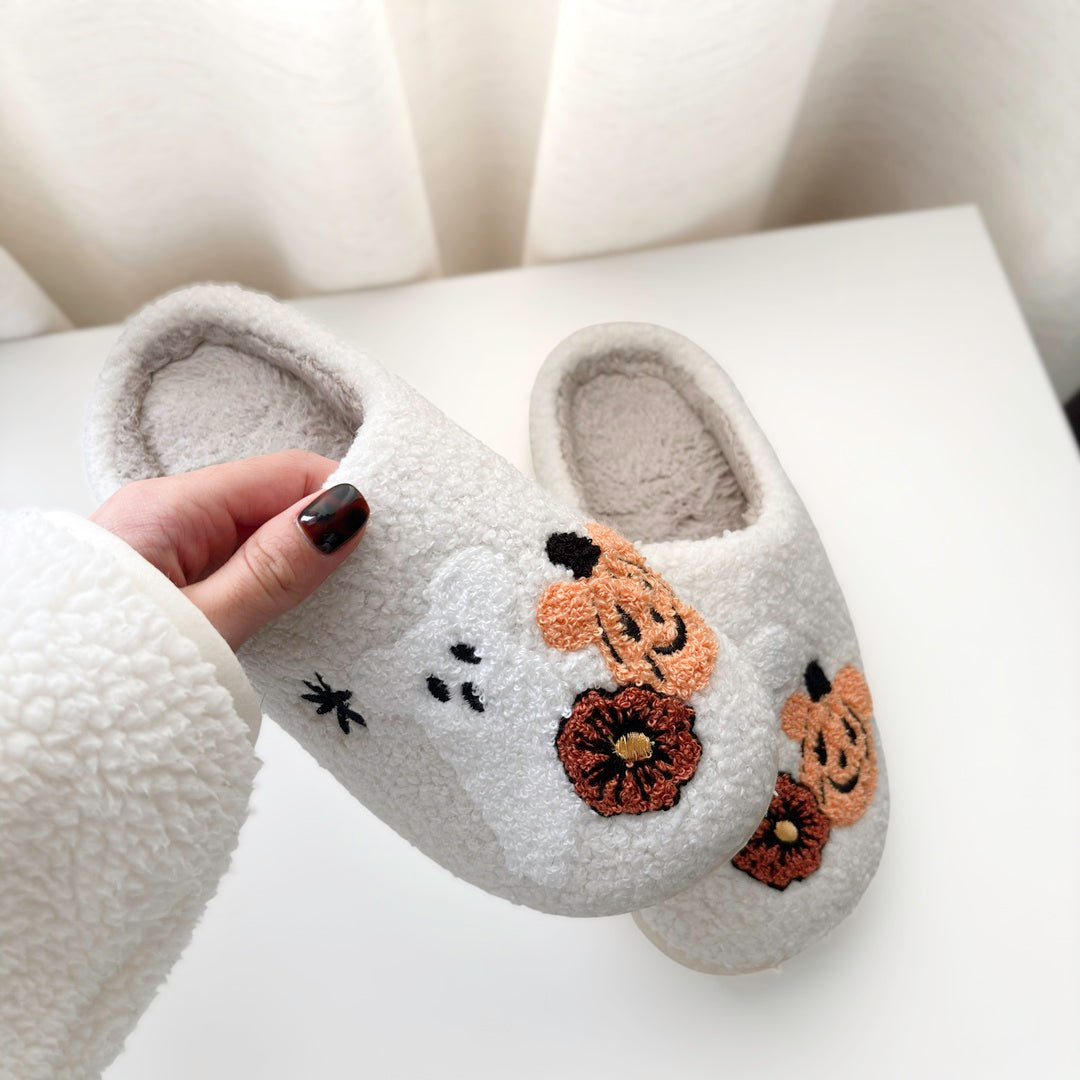 fluffy slippers featuring playful pumpkin and ghost embroidery