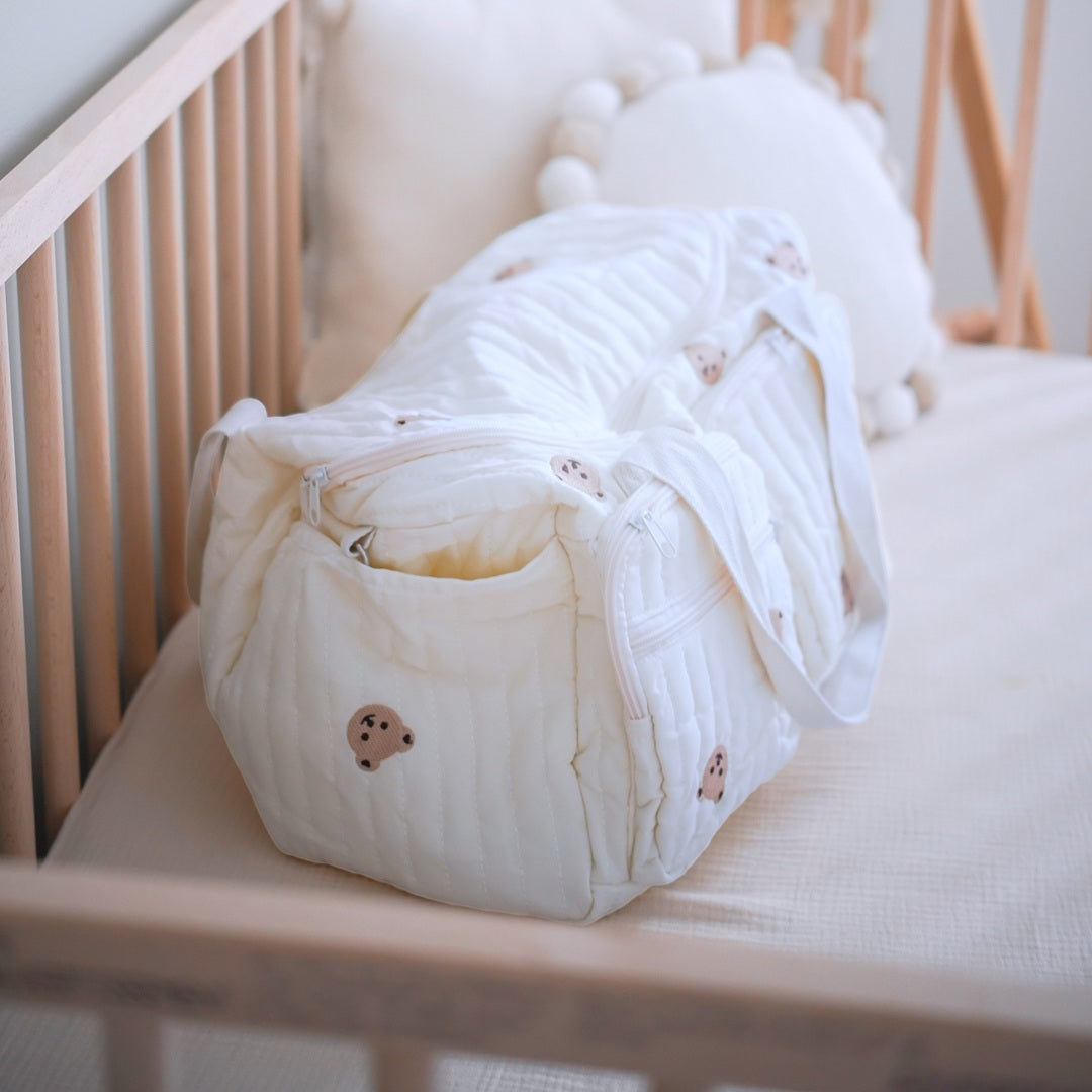 Quilted mom tote bag with front zipper pockets