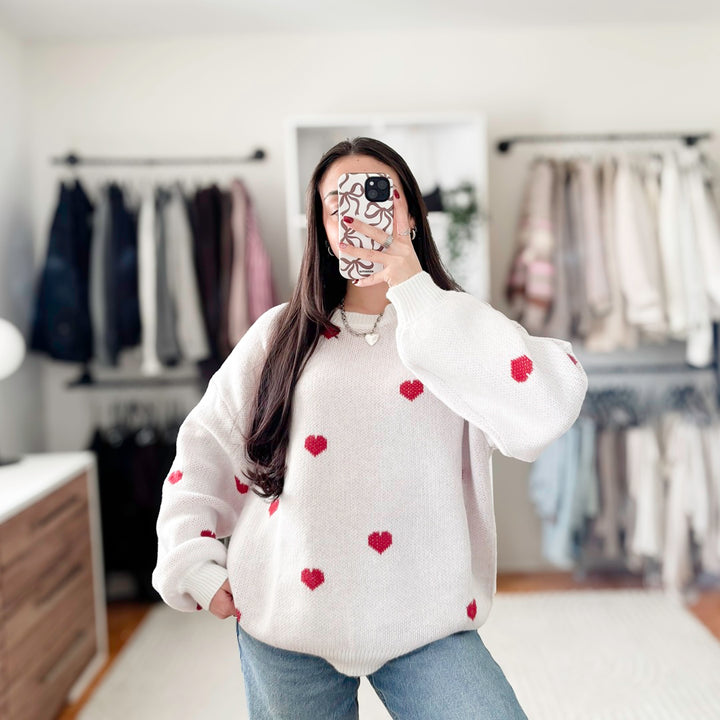 Women’s pullover sweater with red heart pattern and soft knit fabric