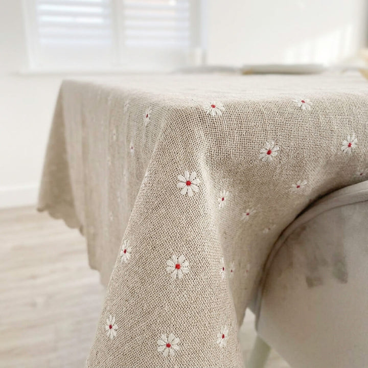 Embroidered floral tablecloth with subtle daisy pattern and soft fabric