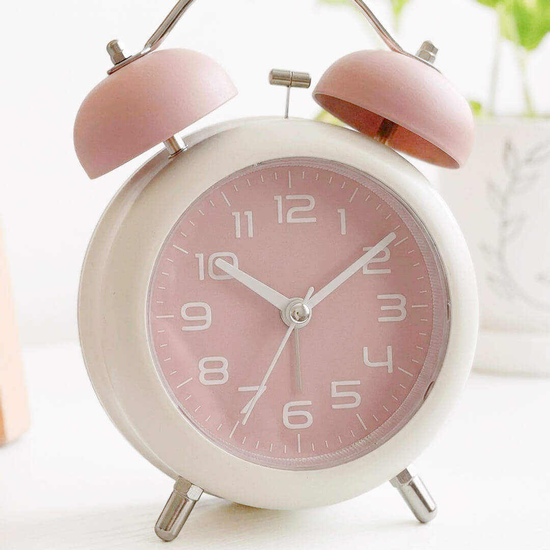 Cute pink alarm clock with classic bell design