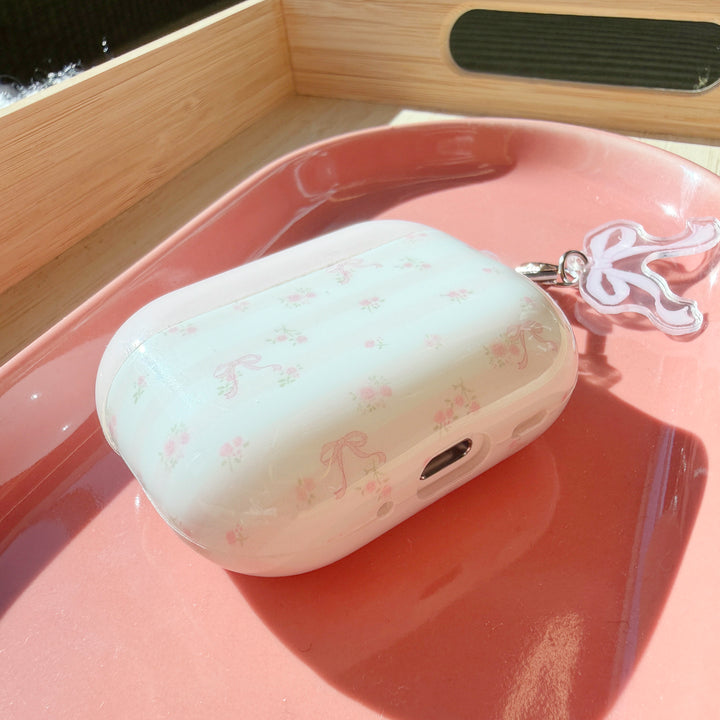 AirPods case with pastel pink ribbon and floral details