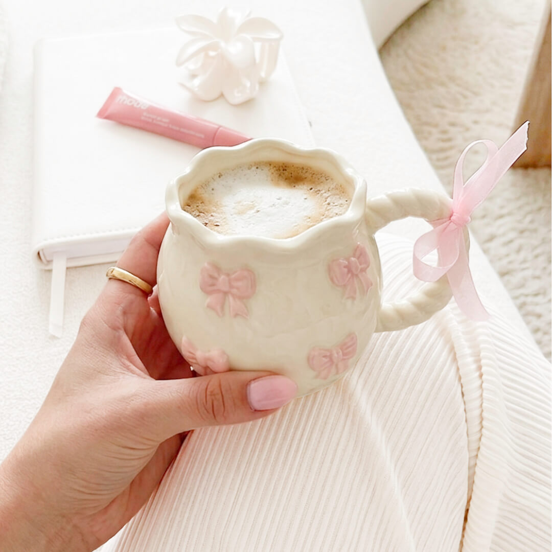 White bow mug with scalloped rim design