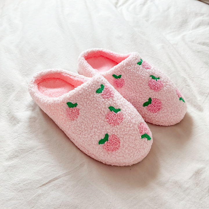 Soft pink house shoes with embroidered peach pattern