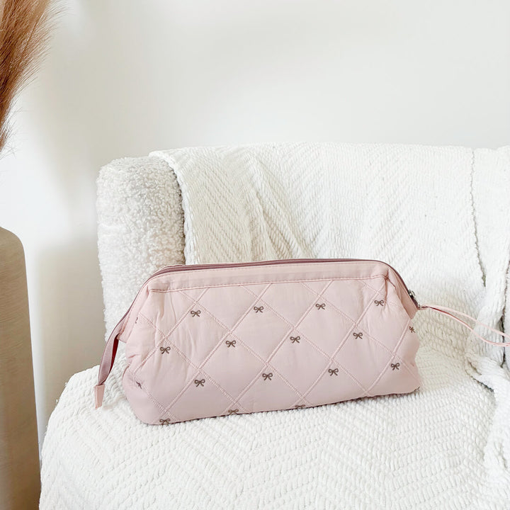 pink quilted makeup bag with bow pattern