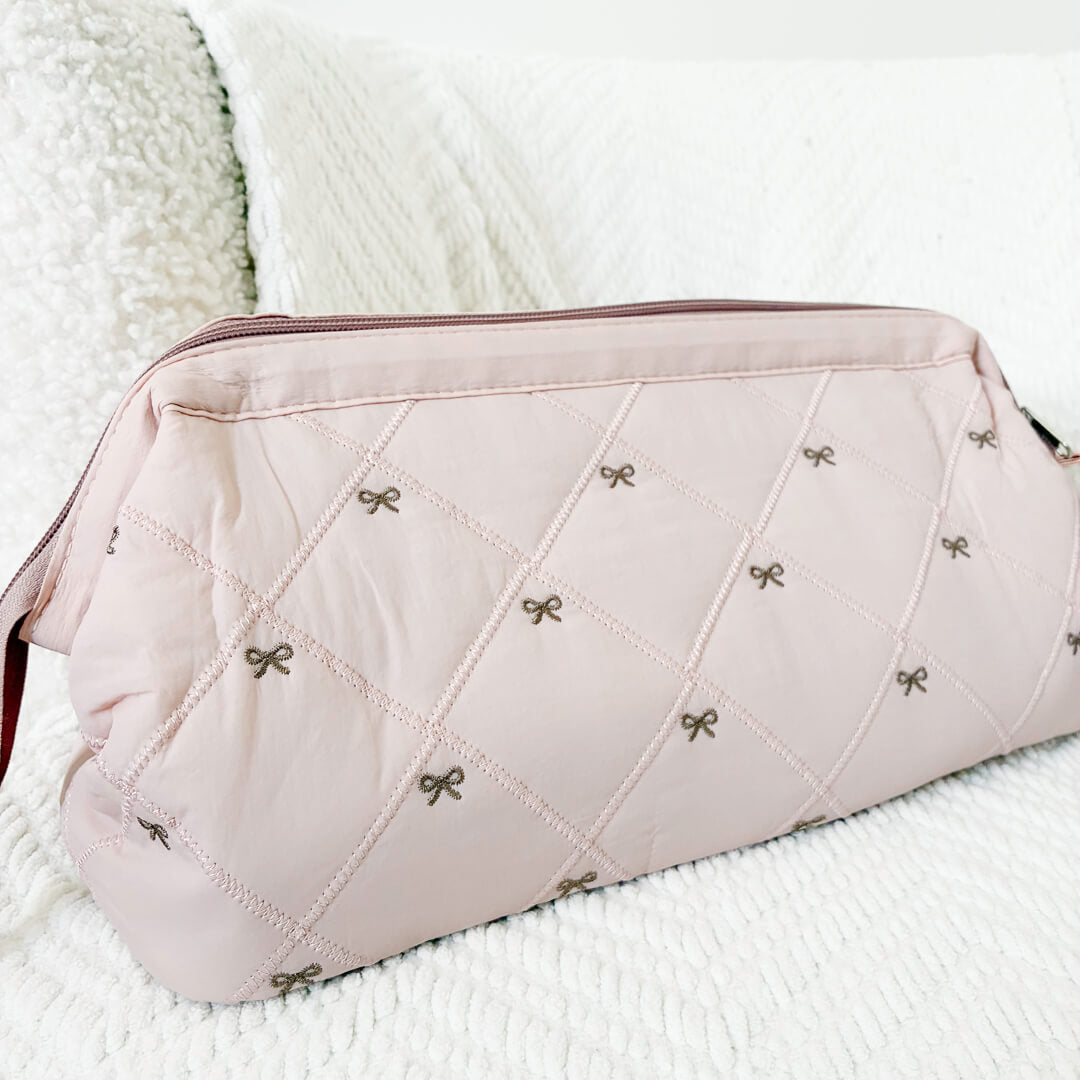 pink quilted bow pouch with zip top closure