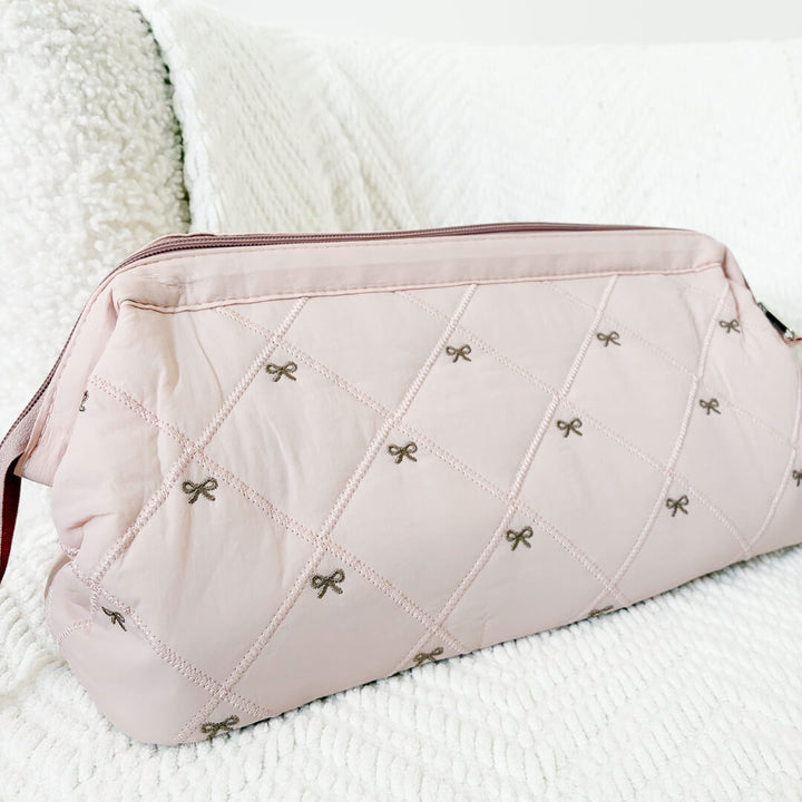 pink quilted bow pouch with zip top closure