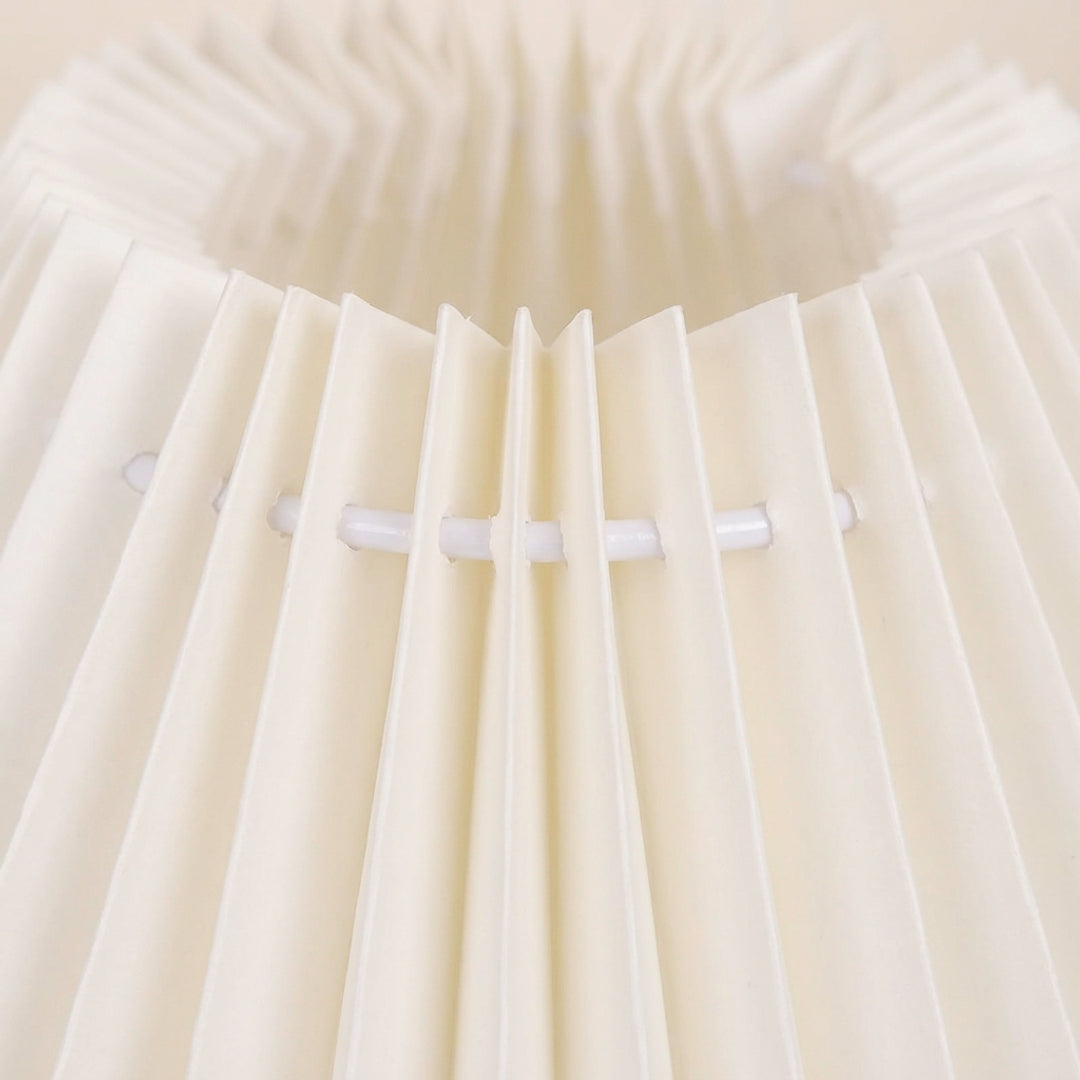 Warm glow pleated nightstand lamp with wooden cylindrical base