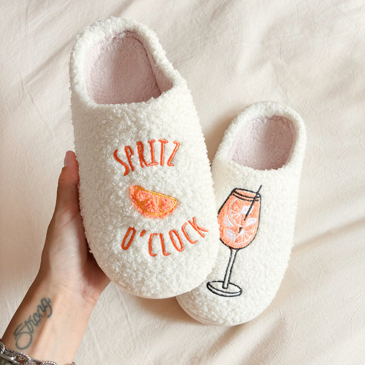 White closed-toe slippers with cocktail-inspired embroidery