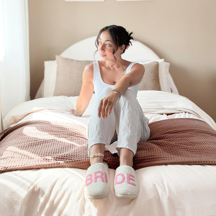 White indoor slippers with pink bride text