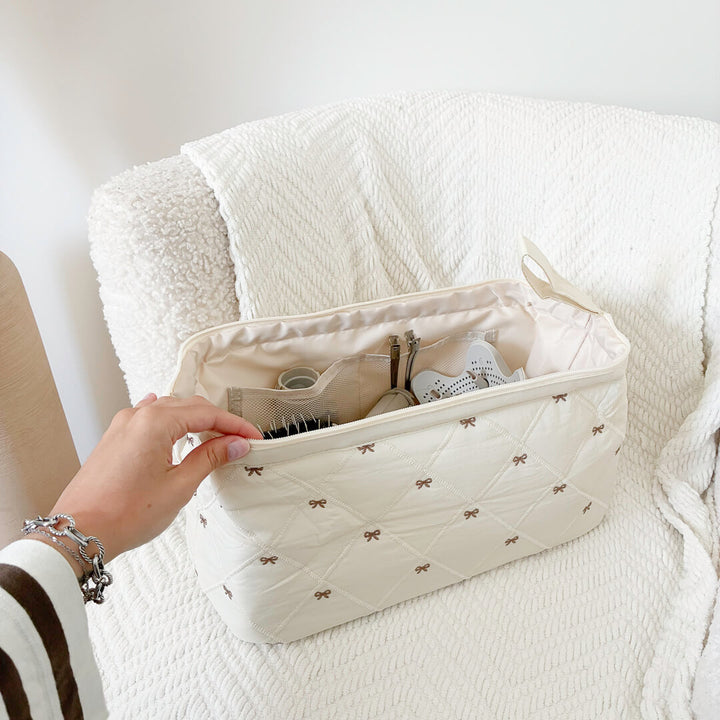 quilted toiletry bag with embroidered bows