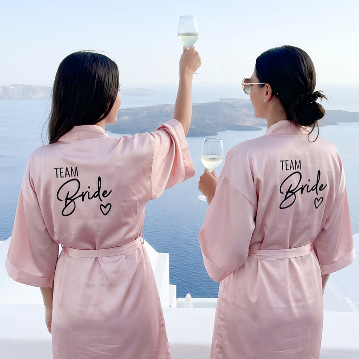 White bride robe with matching blush bridesmaid robes