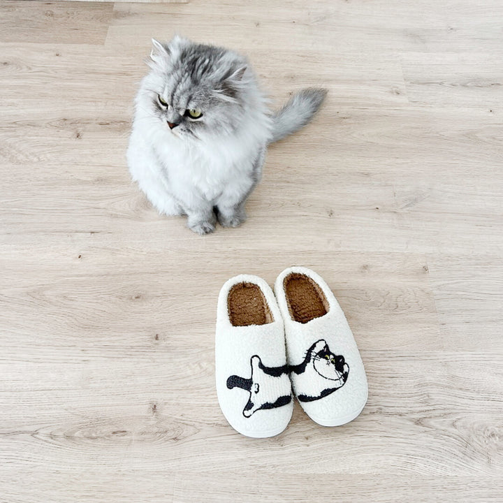 White fuzzy slippers with curled cat embroidery